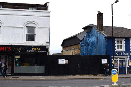 pizza shop and a gap with black hoarding and the Bull Theatre