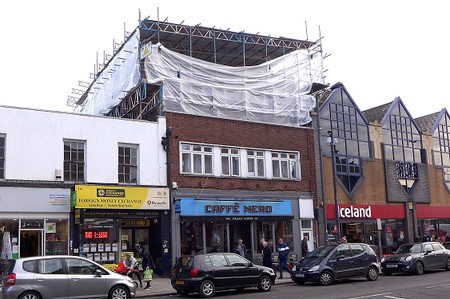 shop with scaffolding over the roof