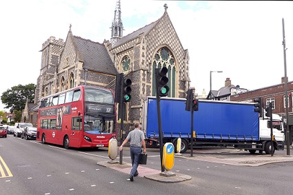 bus and turning lorry in front of church