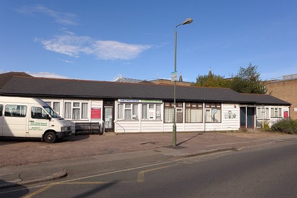 single storey wooden building painted white