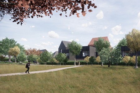 artists impression of rough grassed area with pitched roofs behind