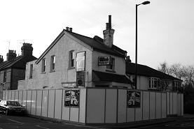 Wheels Car Hire office with hoarding, Barnet