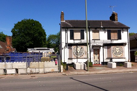 white building boarded up